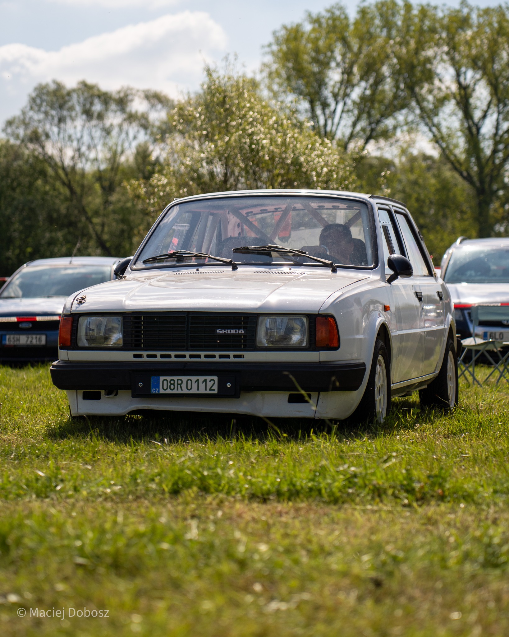 Front view of a white Skoda in a field