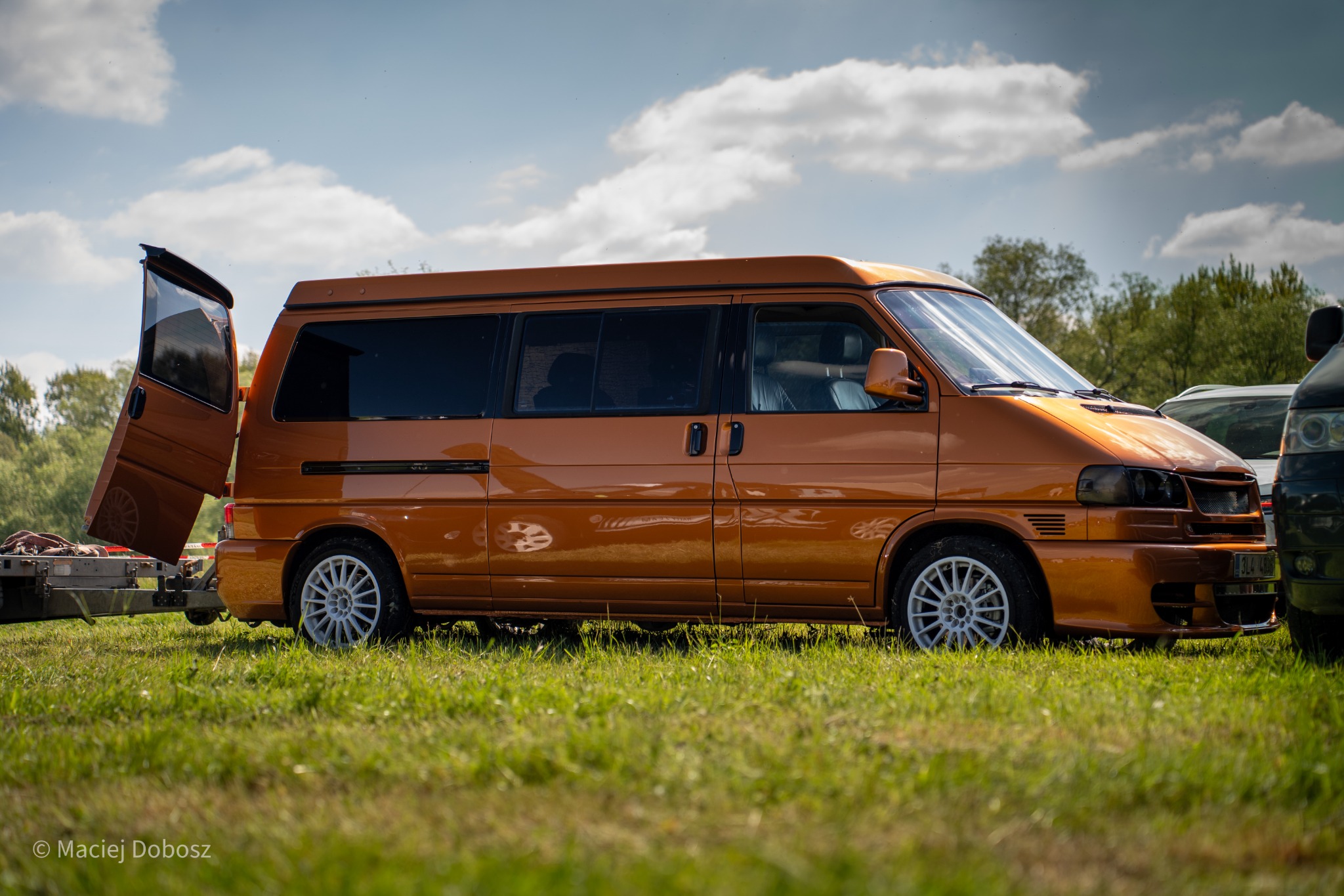 Orange modified van at the automotive event